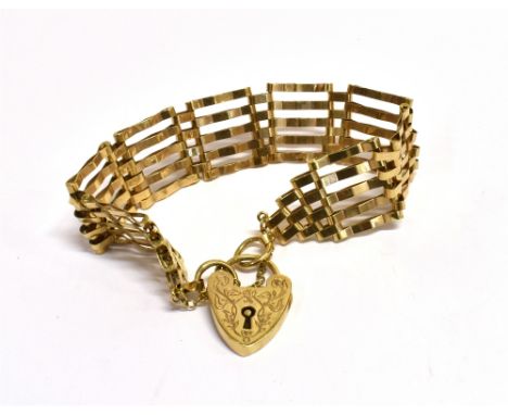 A 9CT GOLD FIVE BAR GATE BRACELET The bracelet fitted with a 9ct gold heart padlock with an engraved front pattern, the padlo