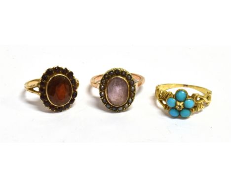 THREE STONE SET RINGS  A turquoise flower ring in yellow metal with open work scroll shoulders, ring size K, weight 3g (sligh