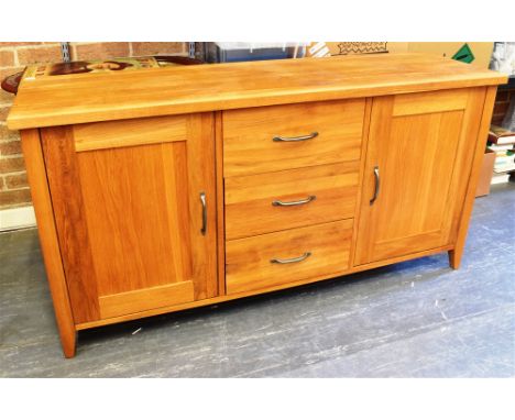 A LIGHT OAK SIDEBOARD  fitted with three drawers flanked by cupboards, 152cm wide 45cm deep 78cm high Condition Report : good