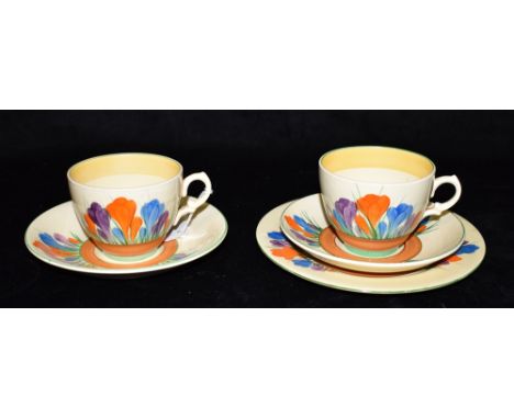 A CLARICE CLIFF BIZARRE WARE TRIO  in 'Crocus' pattern, and another cup and saucer Condition Report : generally good, some li