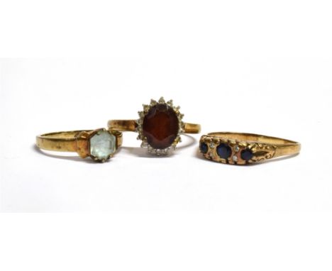 THREE 9CT GOLD, COLOURED STONE DRESS RINGS  Sizes M ½ , R and R ½ , total weight 8g Condition Report : Rings have bent shanks