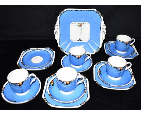 A COLLECTION OF SHELLEY 'LOMOND' SHAPE TEA WARE decorated with fruit and leaves on a blue ground, comprising five cups, six s