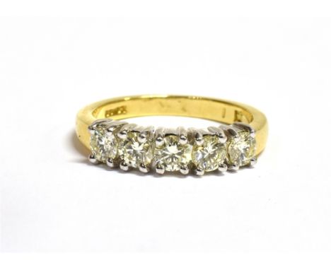 AN 18CT GOLD, DIAMOND FIVE STONE RING The five brilliant cut diamonds each measuring 3.5mm in diameter and set in white metal