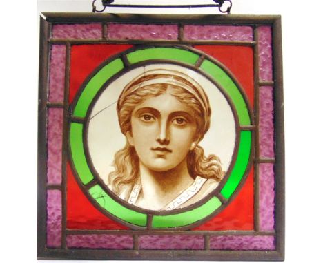 A STAINED GLASS PANEL  the central roundel with a portrait of a young woman, overall 36.5cm x 36.5cm. Condition Report : Port