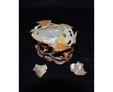 A CHINESE CARVED HARDSTONE DISH MODELLED AS A LEAF  on conforming pierced and carved hardwood stand, the hardstone carving ap