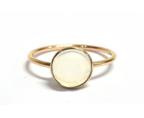 A YELLOW GOLD 'MOONSTONE SET' DRESS RING the single cabochon cut glass moonstone approx. 8mm diameter, tubular shank unmarked