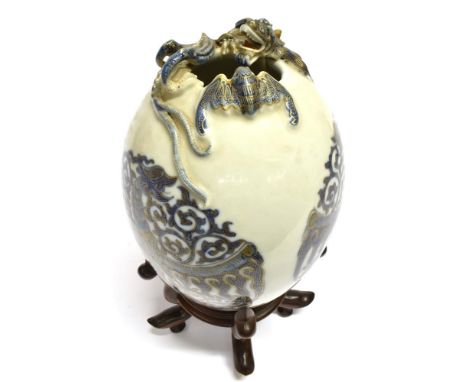 A CHINESE PORCELAIN VASE OF OVOID FORM relief decorated around the rim with a dragon and bat, the body of the vase with three