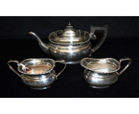 A SILVER THREE PIECE TEA SETthe set comprising a teapot (ebonised handle), sugar bowl and creamery, the set of the same desig