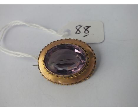 Attractive oval amethyst brooch in 12ct gold - 5.9gms