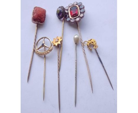 Seven assorted stick pins, garnet cluster, coral, star, horseshoe and three others