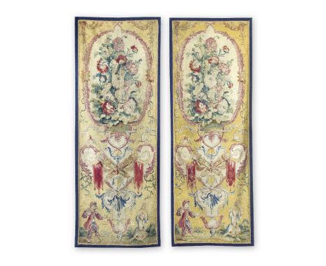 A pair of French tapestry portièresCirca 1720-30, probably GobelinsDesigned with poppies in an oval ivory cartouche above bir