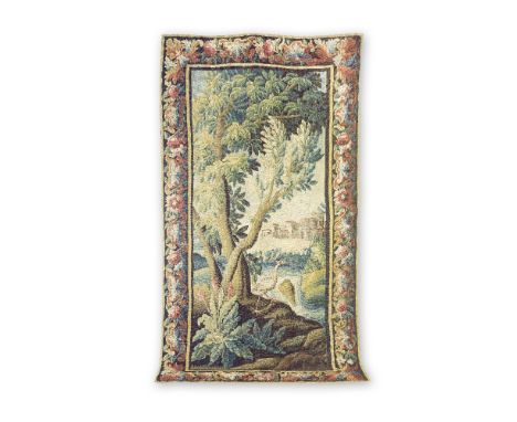 An Aubusson verdure tapestryEarly 18th centuryDesigned with a crane on a riverbank, a waterfall and town to the middle distan