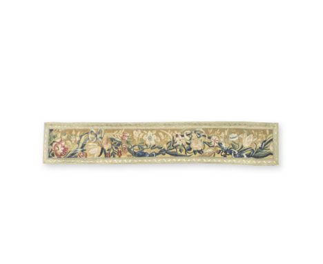 A Flemish tapestry border panelCirca 1700-1720, Brussels or AntwerpDesigned with blue ribbon tied swags, birds and magenta fl