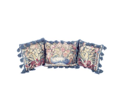 A pair of cushions of tapestry17th century, FrenchDesigned with ribbon tied floral bouquets, and one other of similar design,