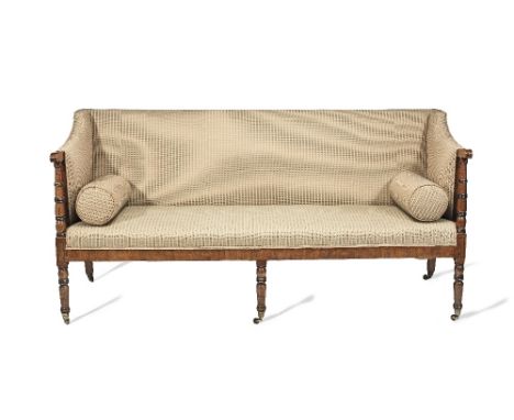 A Regency mahogany and ebonised framed sofaWith upholstered back and seat on ring turned legs and conforming uprights,  188cm