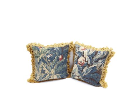 A pair of cushions of verdure tapestry18th century, AubussonDesigned with flowers and leaves, with tassel fringe and velvet b
