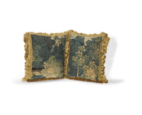 Two cushions of verdure tapestryEarly 18th century, probably AubussonDesigned with trees and leaves, velvet backed, with tass