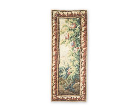 An Aubusson verdure tapestryCirca 1750Designed with a rich green and magenta flowering shrub, a faint town to the middle dist