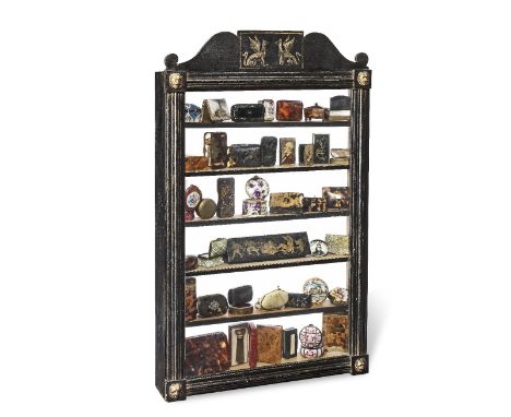 A cabinet of curiosities19th century and laterThe Regency style ebonised cabinet, containing a collection of pill boxes, card