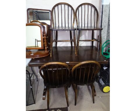 A rectangular oak draw leaf dining table, together with a set of 4 matching stick-back chairs