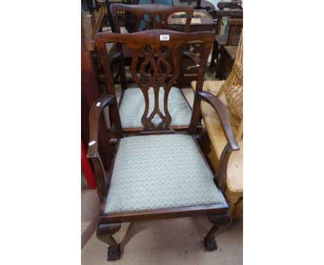 A pair of Chippendale style mahogany elbow chairs, on claw and ball feet