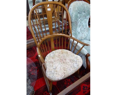 An Ercol stained elm comb-back rocking chair