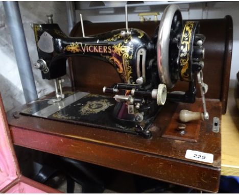 A Vickers sewing machine with case, and a portable typewriter