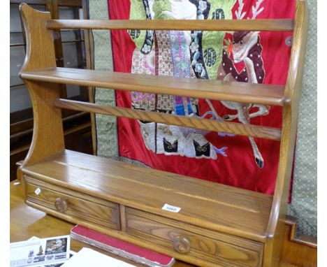A Ercol elm hanging shelf unit with 2 short drawers, W70cm