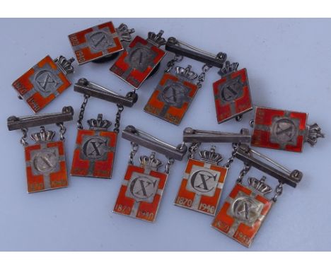 Eleven Georg Jensen silver and enamel commemorative badges in three forms. 