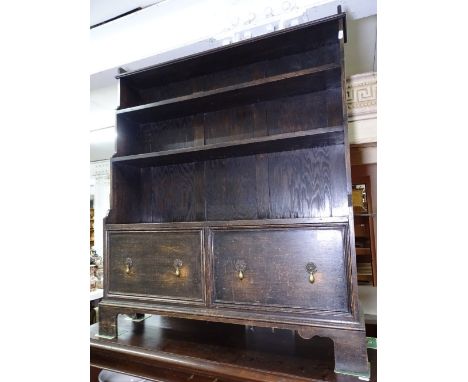 An oak open waterfall bookcase, with drawers to the base on bracket feet, W94cm