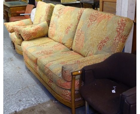 An Ercol elm bow-end 3-seater settee, with upholstered loose cushions, and a matching armchair