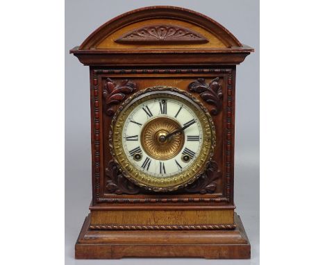 A 2-train mantel clock in carved mahogany case, 14"