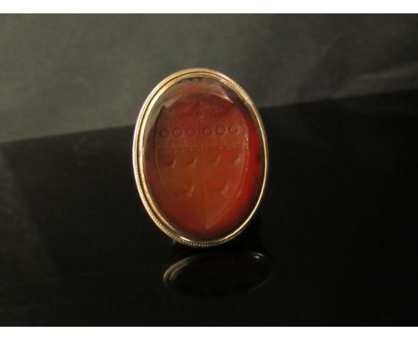 A Victorian gold ring with oval cornelian carved intaglio of a bearded gentleman, unmarked. Size Q, 3.7g 