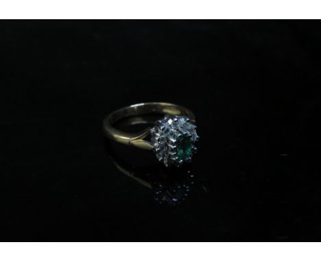 A 9ct gold emerald and diamond cluster ring. Size M, 3.1g 