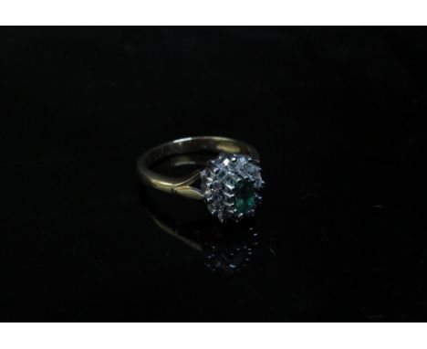 A 9ct gold emerald and diamond cluster ring. Size M, 3.1g 