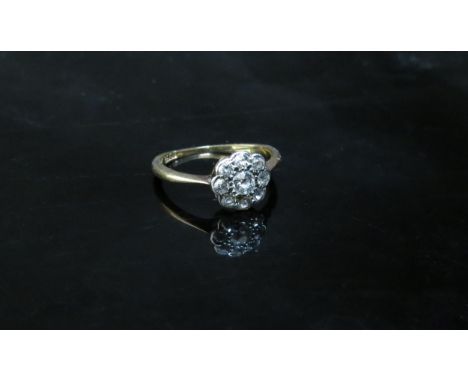 A diamond daisy ring, back of mount damaged, stamped 18ct, 1.7g 