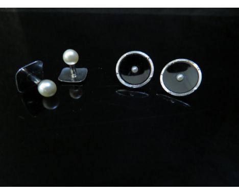 A pair of black enamel and pearl set studs stamped 18ct and a pair platinum studs 