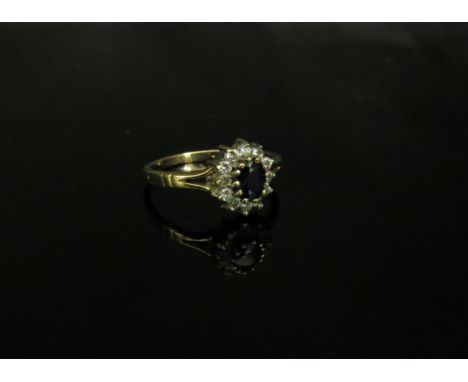 A 9ct gold sapphire and white stone cluster ring. Size L, 1.7g 