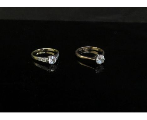 Two gold rings both set with clear stones, one with diamond set shoulders, 9ct and unmarked, replaced shank. Sizes N/O and R,