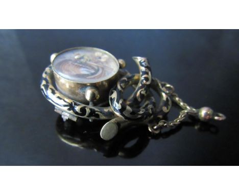 A Victorian gold memoriam pendant/brooch with black enamel decoration, hair panel decoration to front, unmarked, 5.5cm drop, 