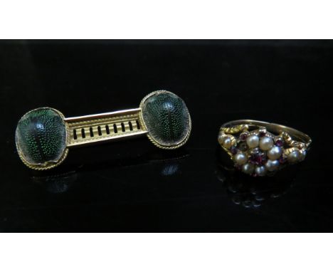 An unmarked gold, ruby and pearl ring a/f and a scarab brooch 