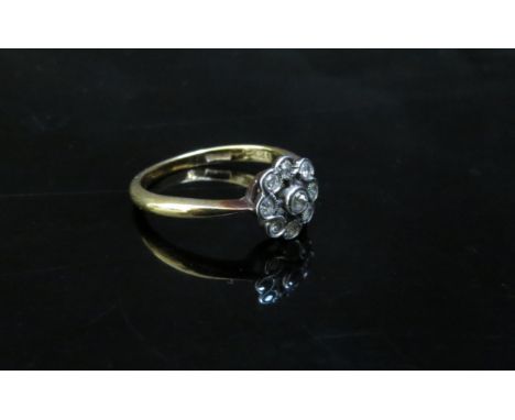 A gold diamond daisy ring, stamped 18ct. Size N, 2.8g 