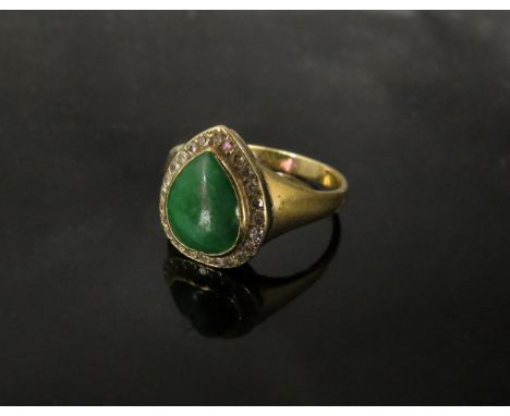 A gold ring with pear cut cabochon jade to centre framed by old cut diamonds, stamped 18ct. Size M, 4.2g 