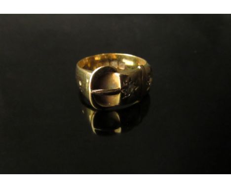 An 18ct gold buckle ring set with two diamonds in rubover star settings. Size O, 7.4g 