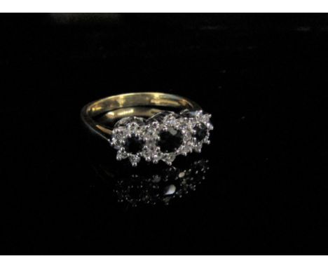 An 18ct gold sapphire and diamond triple cluster ring. Size O, 3.7g 