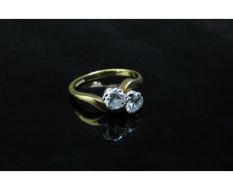 A 18ct gold double diamond crossover ring, 1ct approx total. Size L/M, 3.8g