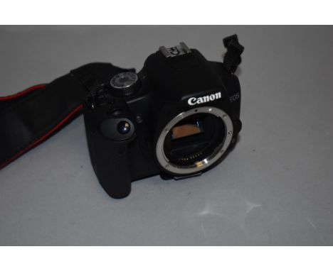 A Canon EOS 500D body with manual in soft bag. Camera turns on and responds noy tested for functionallity