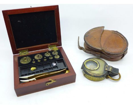 A cased pocket compass and a set of brass weights, box marked L. Oertling, London