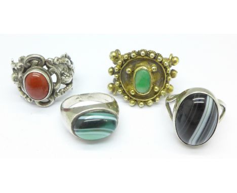 Three silver rings and one other ring
