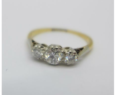 An 18ct gold, three stone diamond ring, 1.9g, L